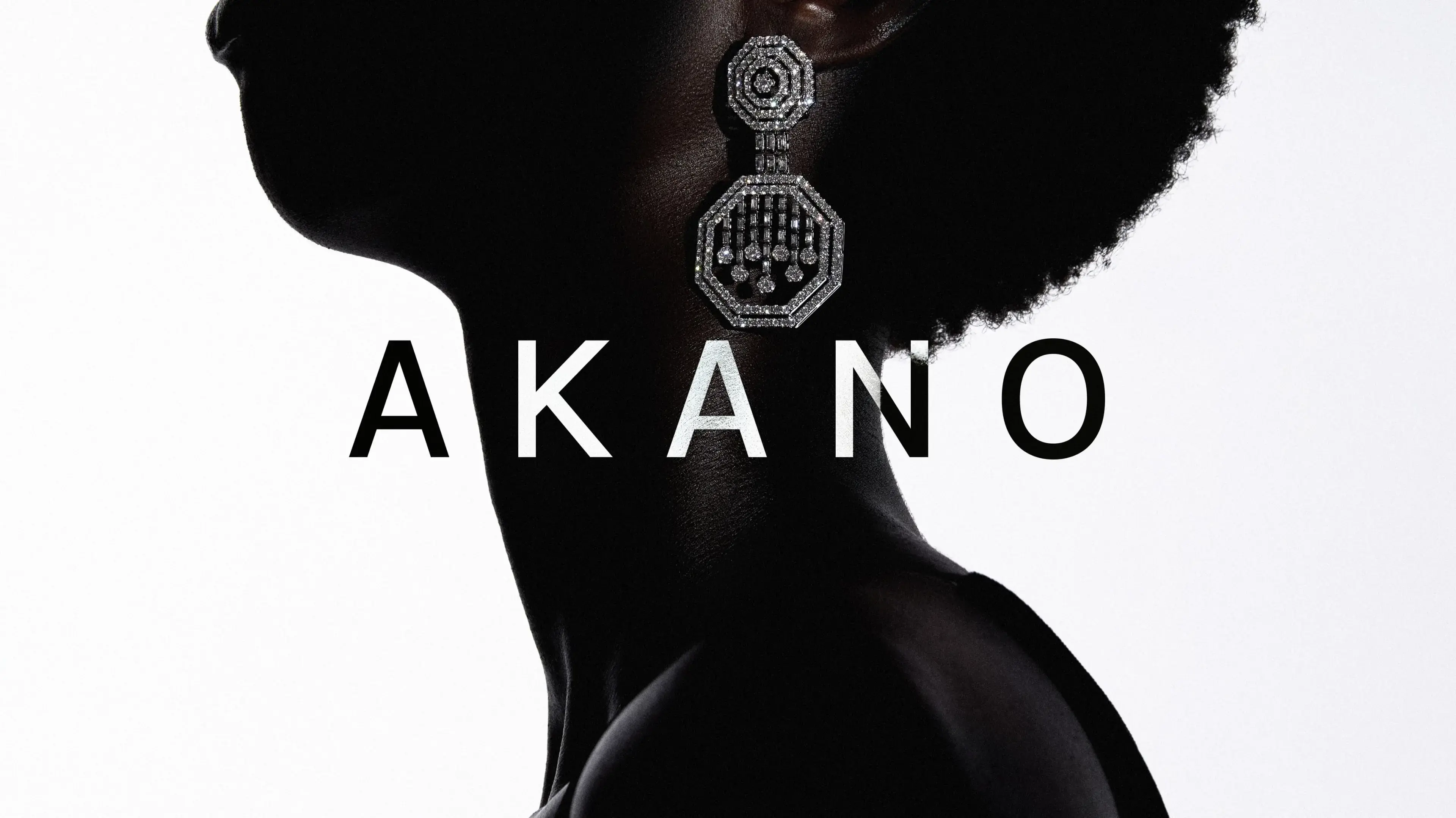 AKANO hero: a black-and-white profile silhouette of a model wearing an ornate octagonal diamond drop earring, with the AKANO wordmark set across the neckline.